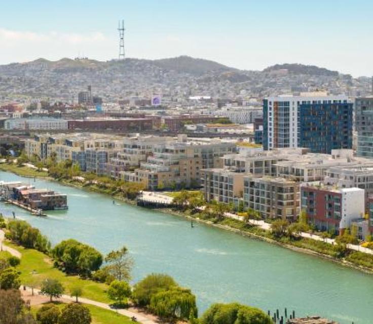 A River With Buildings And Trees By It